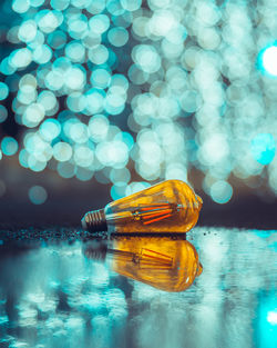 Close-up of illuminated lights in glass container on table