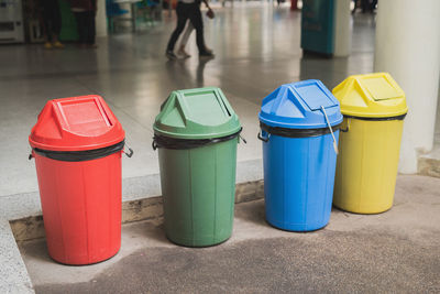 Colorful garbage bins on footpath