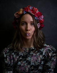 Portrait of a beautiful young woman with red flower