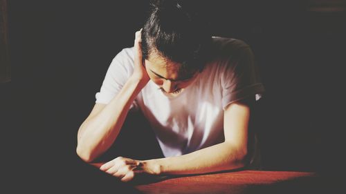 Midsection of man sitting at home