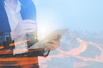 Digital composite image of man and buildings against sky