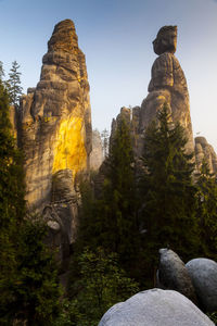 Statue against rock formation