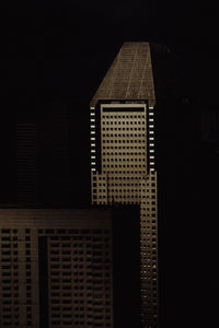 Low angle view of buildings against sky at night