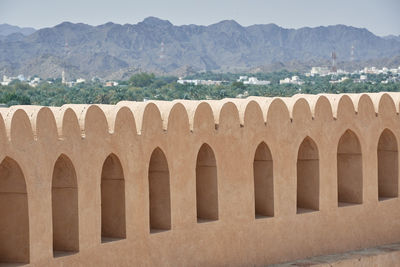 View of historical building with mountain range in background