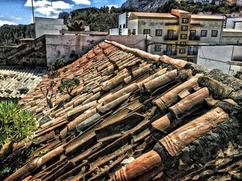 Stack of logs against sky