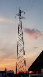 Low angle view of electricity pylon against the sky