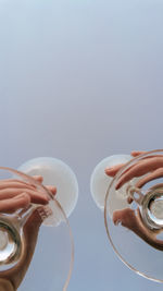 Cropped hand of woman holding wineglasses