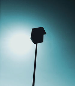 Low angle view of street light against blue sky