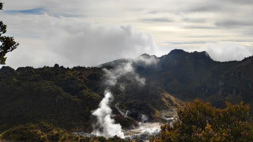 Scenic view of waterfall against sky