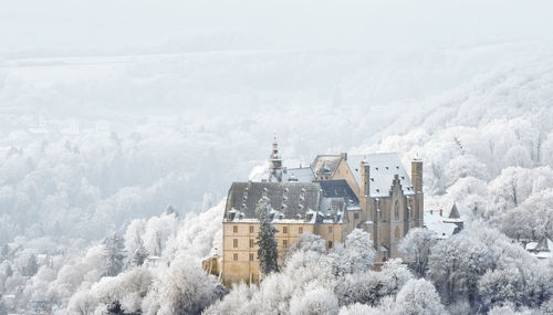 Panoramic view of buildings and snowcapped mountain during winter