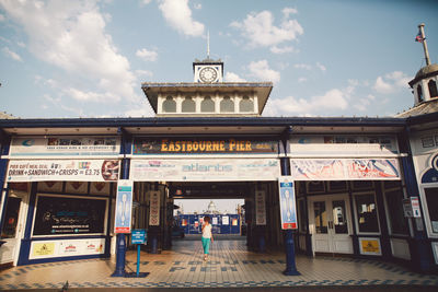 Full length of woman standing at eastbourne pier