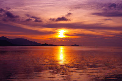 Scenic view of sea against romantic sky at sunset