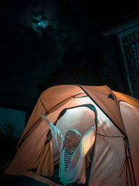 People in tent against sky at night