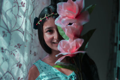 Portrait of woman with pink flowers