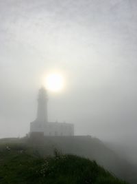 Sun shining over mountain against sky