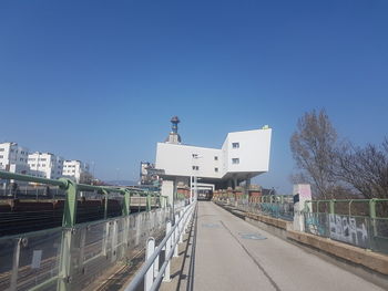 View of railroad station against clear blue sky