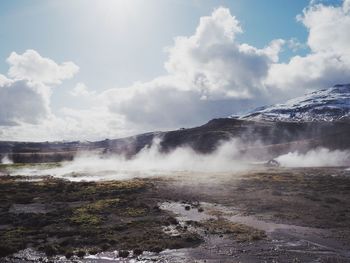 Scenic view of waterfall against sky