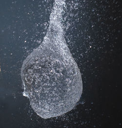 Close-up of water splashing against black background