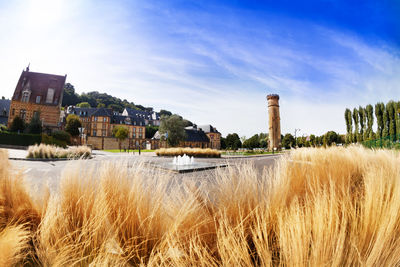 Scenic view of river by buildings against sky