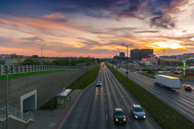 High angle view of cars on street against sky during sunset