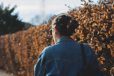 Rear view of woman by plants