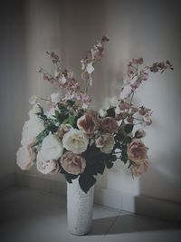 Close-up of white flower vase on floor against wall