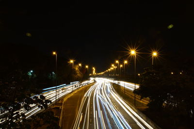 High angle view of light trails on road at night