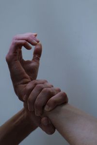 Cropped image of man holding hands