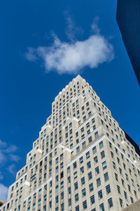 Low angle view of modern building against blue sky