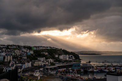 High angle view of townscape by sea against sky