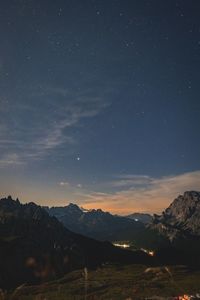 Scenic view of mountains against sky at night