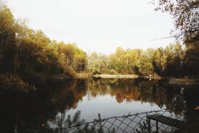 Scenic view of lake in forest against sky