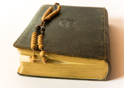 Close-up of open book on table against white background