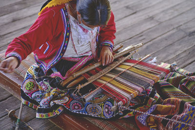 Rear view of woman sitting on street