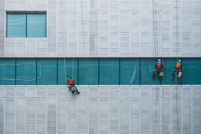 Rear view of people walking on footpath