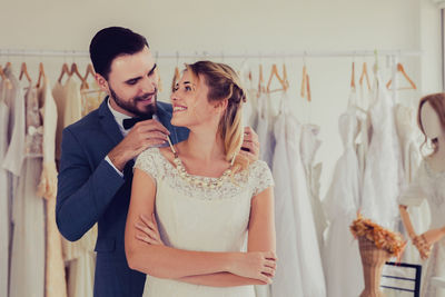 Young couple standing against wall