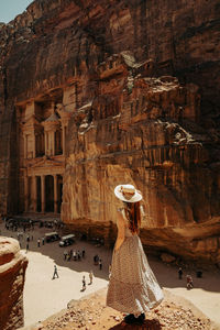 Rear view of woman standing in cave