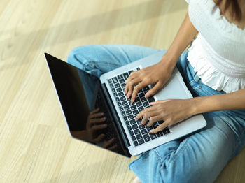 High angle view of woman using laptop in library