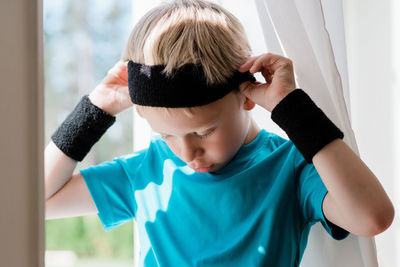 Young boy with sweat bands on ready to play sport