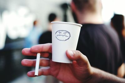 Close-up of cropped hand holding drink