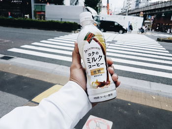 Midsection of person crossing road