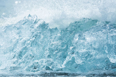 Close-up of water splashing on ice in sea