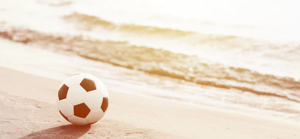 Close-up of soccer ball on beach
