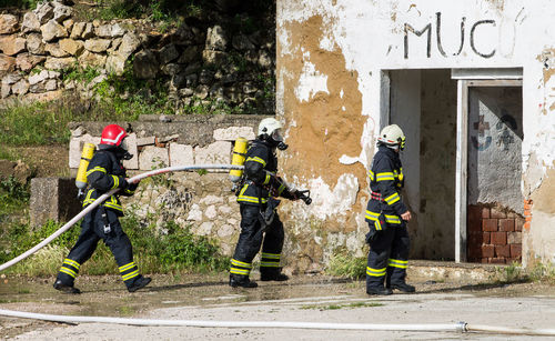 Men with umbrella against built structure