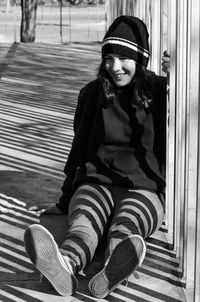 Portrait of a young woman sitting outdoors
