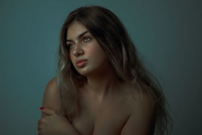 Portrait of a beautiful young woman over gray background