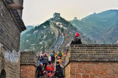 People standing on steps of the great wall of china