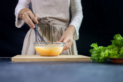 Midsection of man preparing food on table