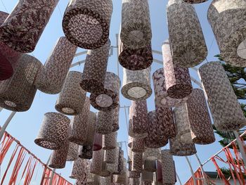 Low angle view of decorations hanging on building against sky