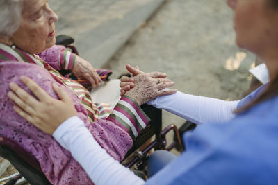 Side view of senior woman sitting outdoors